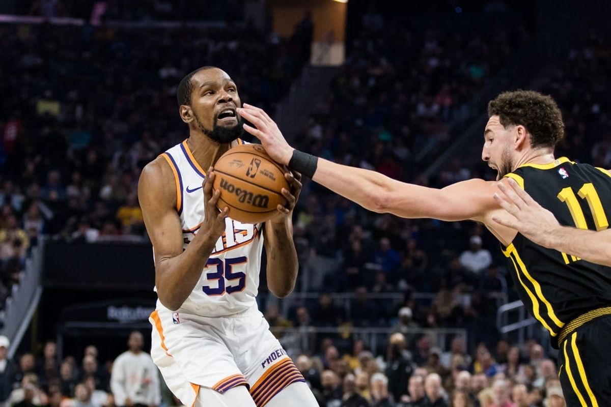 Feb 10, 2024; San Francisco, California, USA; Phoenix Suns forward Kevin Durant (35) is defended by Golden State Warriors guard Klay Thompson (11)  during the first half at Chase Center.