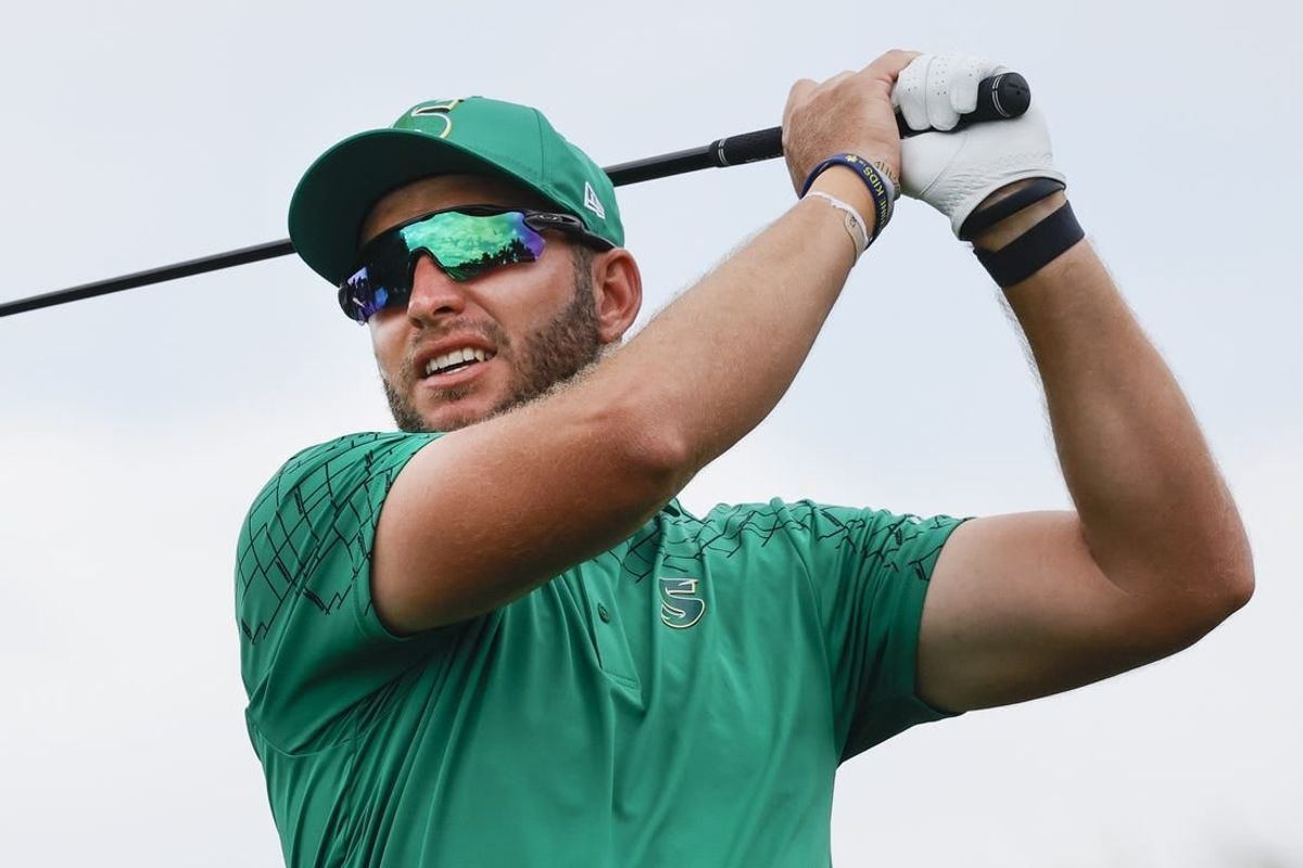 Apr 7, 2024; Miami, Florida, USA; Dean Burmester of the Stinger golf club plays his shot from the eighth tee during the final round of LIV Golf Miami golf tournament at Trump National Doral.