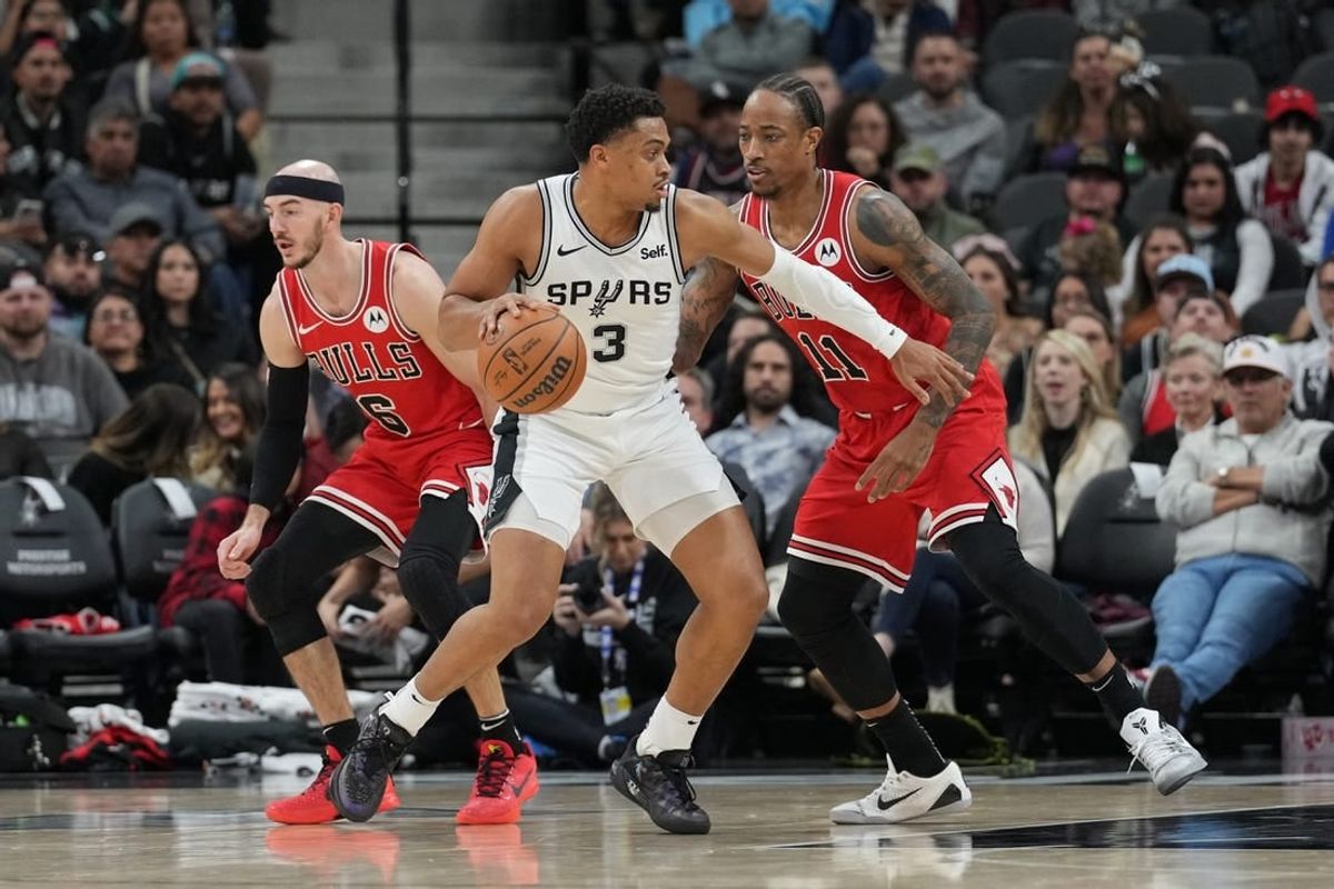 Jan 13, 2024; San Antonio, Texas, USA;  San Antonio Spurs forward Keldon Johnson (3) dribbles against Chicago Bulls forward DeMar DeRozan (11) in the first half at Frost Bank Center.
