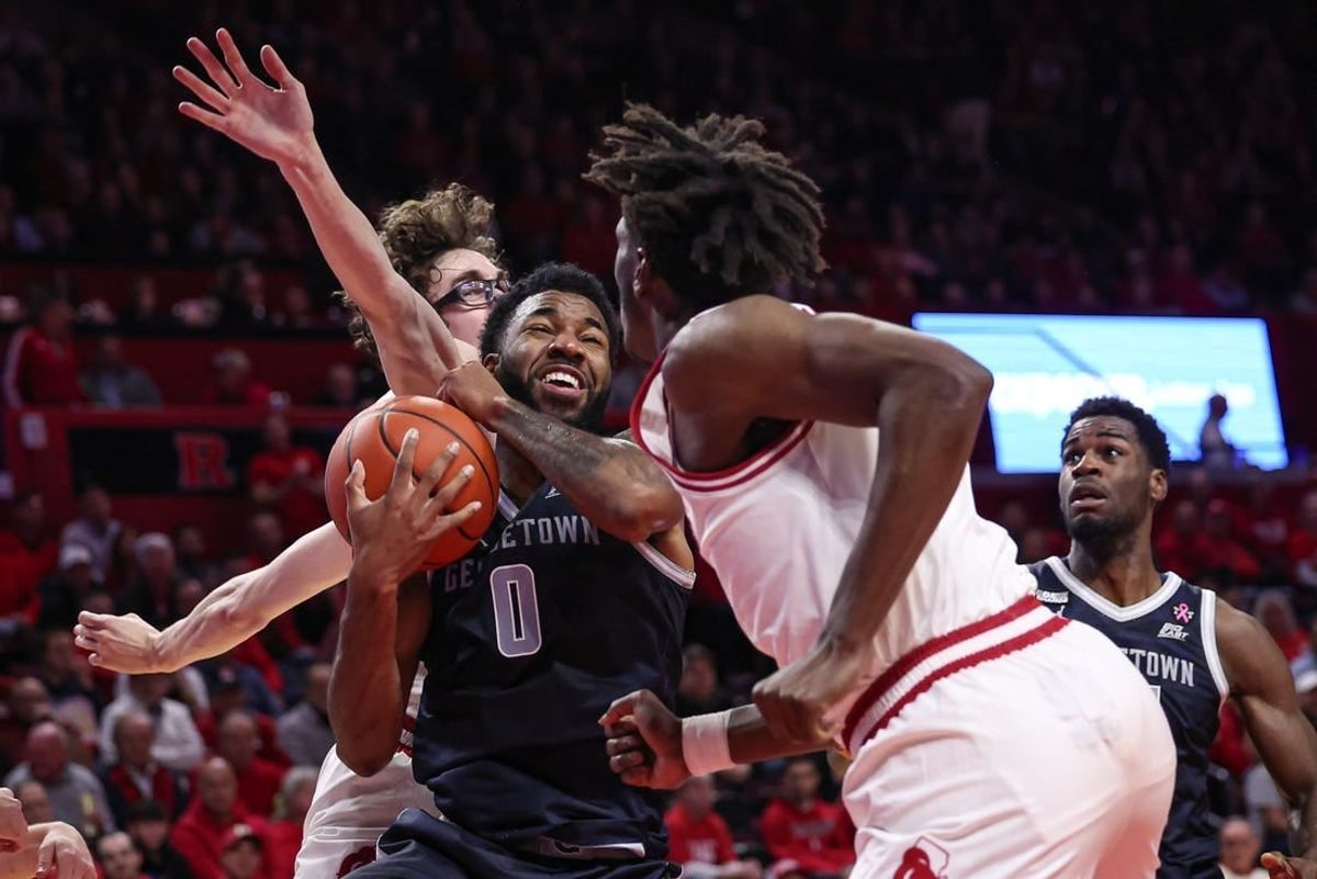 Nov 15, 2023; Piscataway, New Jersey, USA; Georgetown Hoyas guard Dontrez Styles (0) drives to the basket against Rutgers Scarlet Knights guard Gavin Griffiths (10) and forward Antwone Woolfolk (13) during the first half at Jersey Mike's Arena.
