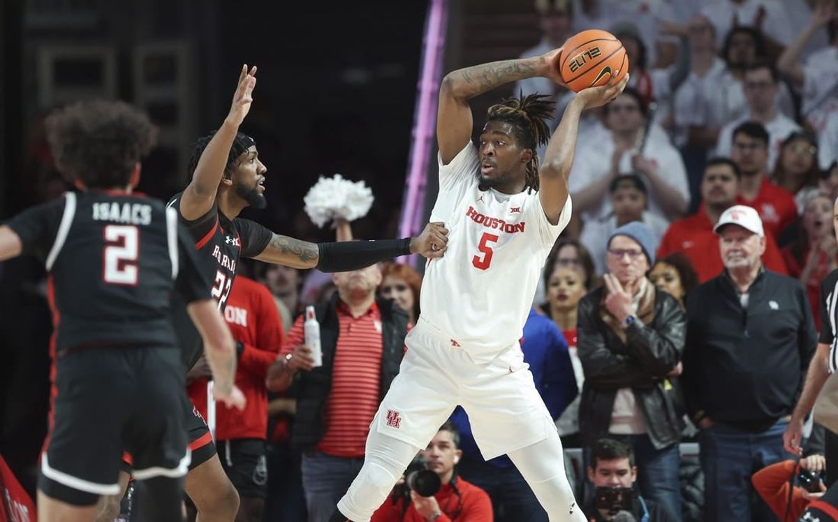 Jan 17, 2024; Houston, Texas, USA; Houston Cougars forward Ja'Vier Francis (5) controls the ball during the first half against the Texas Tech Red Raiders at Fertitta Center.
