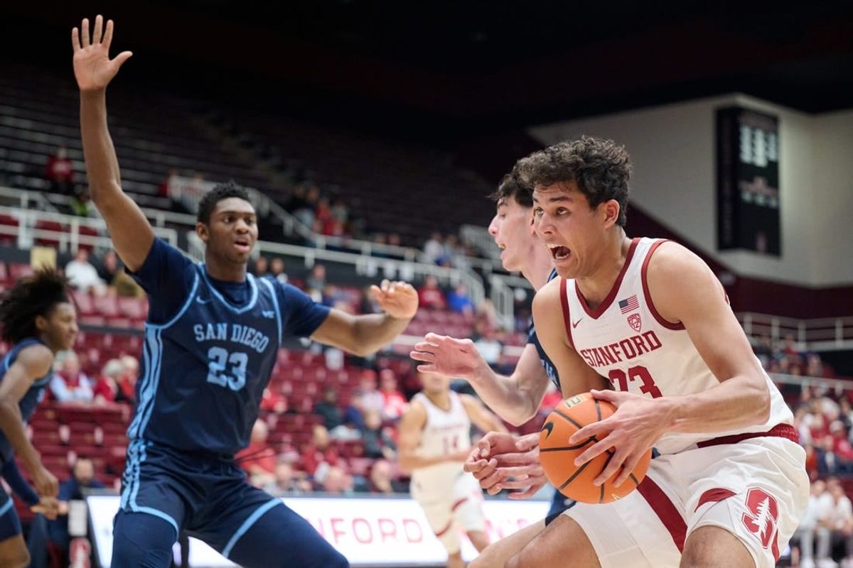 Dec 3, 2023; Stanford, California, USA; Stanford Cardinal forward Brandon Angel (23) controls the ball against San Diego Toreros forward Jimmy Oladokun Jr. (23) during the first half at Maples Pavilion.
