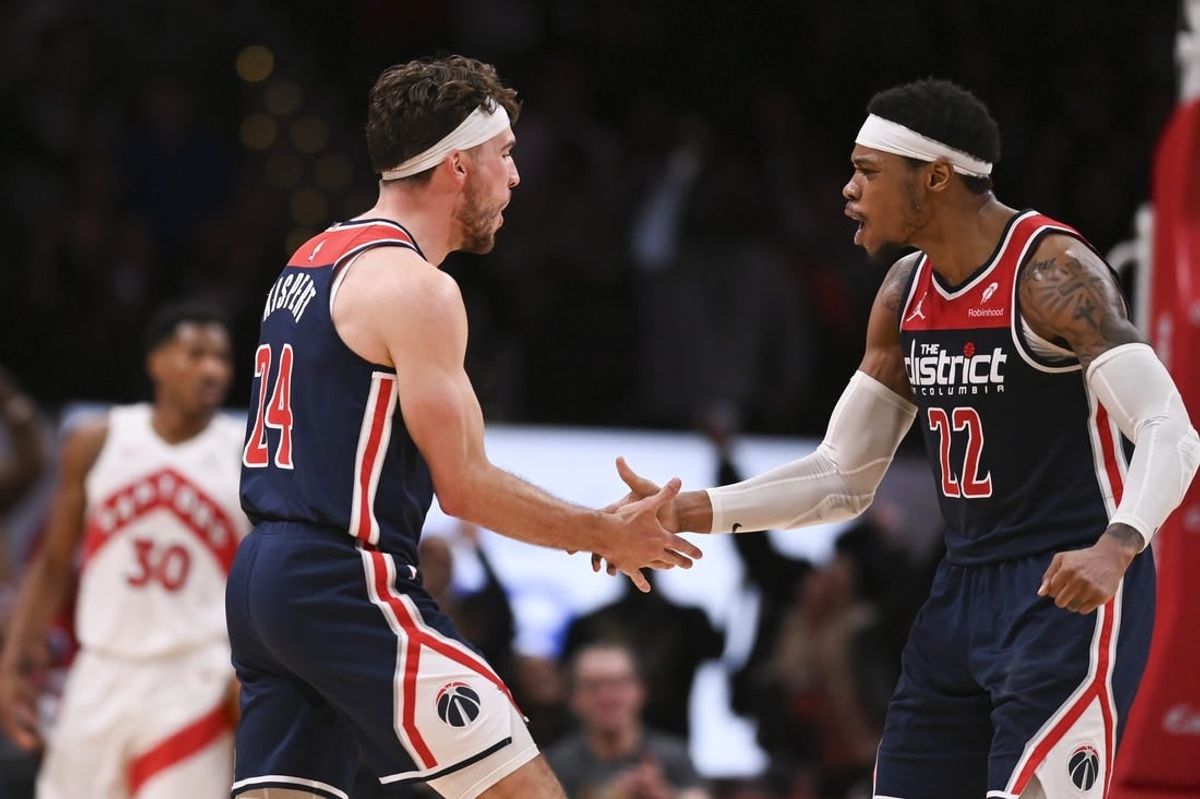 Mar 23, 2024; Washington, District of Columbia, USA; Washington Wizards forward Corey Kispert (24) celebrates with forward Richaun Holmes (22) after scoring a three point basket  during the second half against the Toronto Raptors at Capital One Arena.