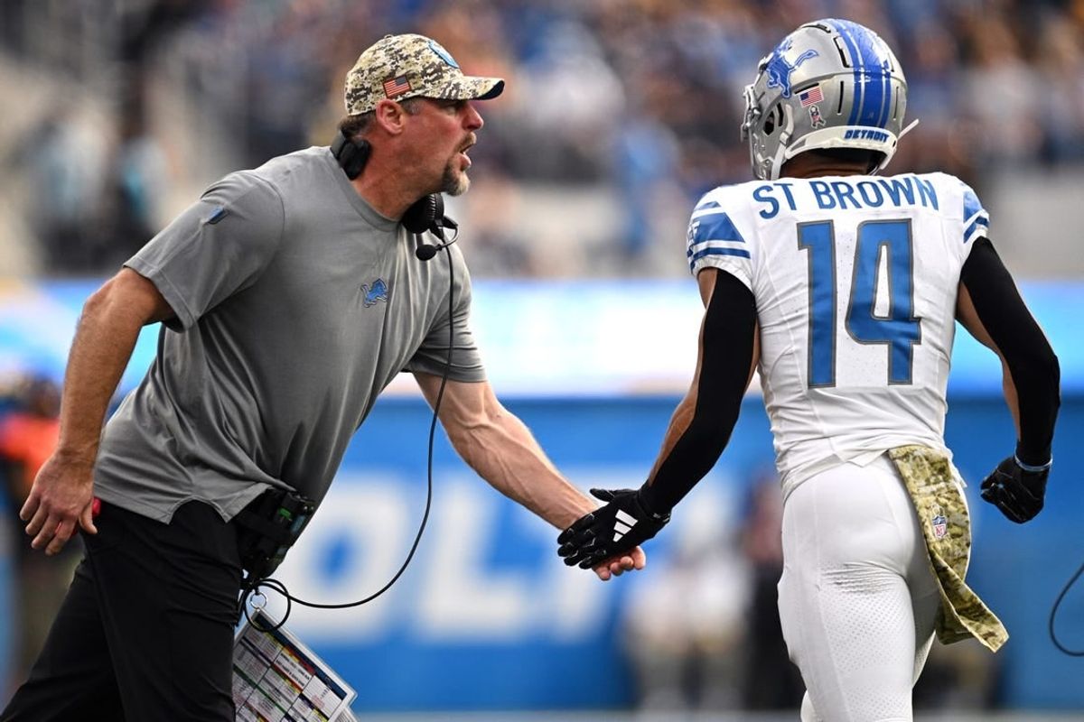 Nov 12, 2023; Inglewood, California, USA; Detroit Lions head coach Dan Campbell (left) congratulates wide receiver Amon-Ra St. Brown (14) after a Lions touchdown  against the Los Angeles Chargers during the first half at SoFi Stadium.
