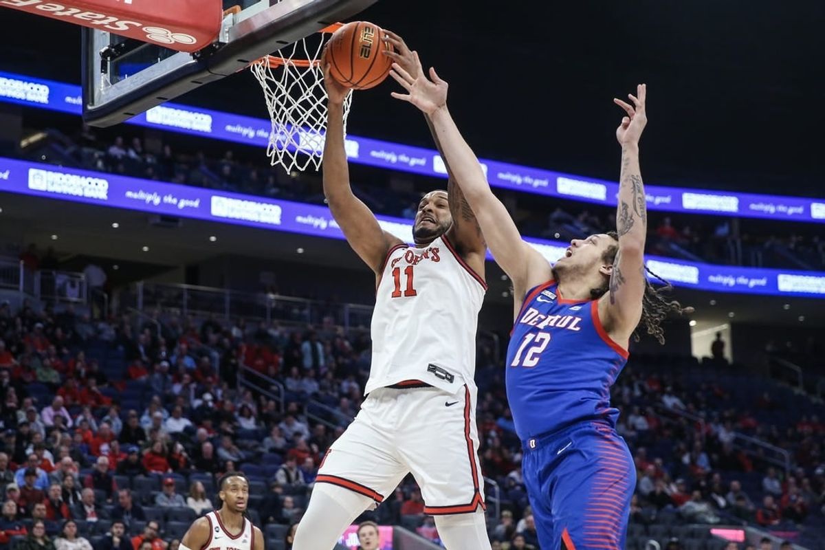 Feb 6, 2024; Elmont, New York, USA; St. John's Red Storm center Joel Soriano (11) and DePaul Blue Demons forward Mac Etienne (12) fight for a rebound in the first half at UBS Arena.