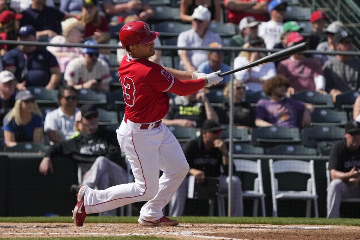 Mar 8, 2023; Tempe, Arizona, USA; Los Angeles Angels catcher Max Stassi (33) hits a single against the Colorado Rockies in the fourth inning at Tempe Diablo Stadium.