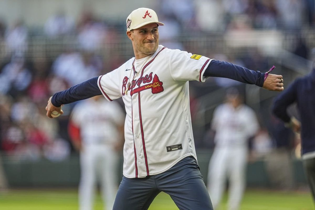 Apr 21, 2024; Cumberland, Georgia, USA; Atlanta Falcons quarterback Kirk Cousins throws out the first pitch prior to the game between the Atlanta Braves against the Texas Rangers at Truist Park.