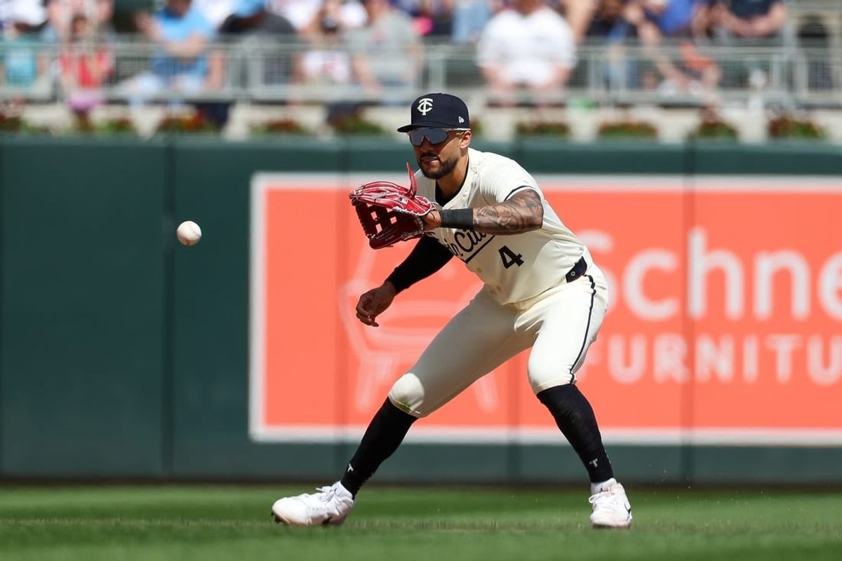 Apr 10, 2024; Minneapolis, Minnesota, USA; Minnesota Twins shortstop Carlos Correa (4) fields the ball hit by Los Angeles Dodgers second baseman Mookie Betts (not pictured) during the seventh inning at Target Field.