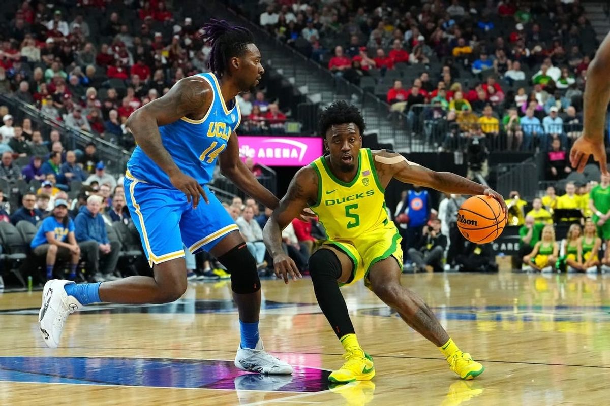 Mar 14, 2024; Las Vegas, NV, USA;Oregon Ducks guard Jermaine Couisnard (5) dribbles against UCLA Bruins forward Kenneth Nwuba (14) during the first half at T-Mobile Arena.