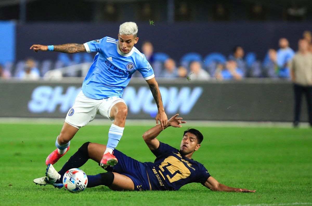 NYCFC midfielder Santiago Rodriguez jumps over Pumas’ midfielder Gerardo Moreno during a 2021 Leagues Cup Quarterfinals match.