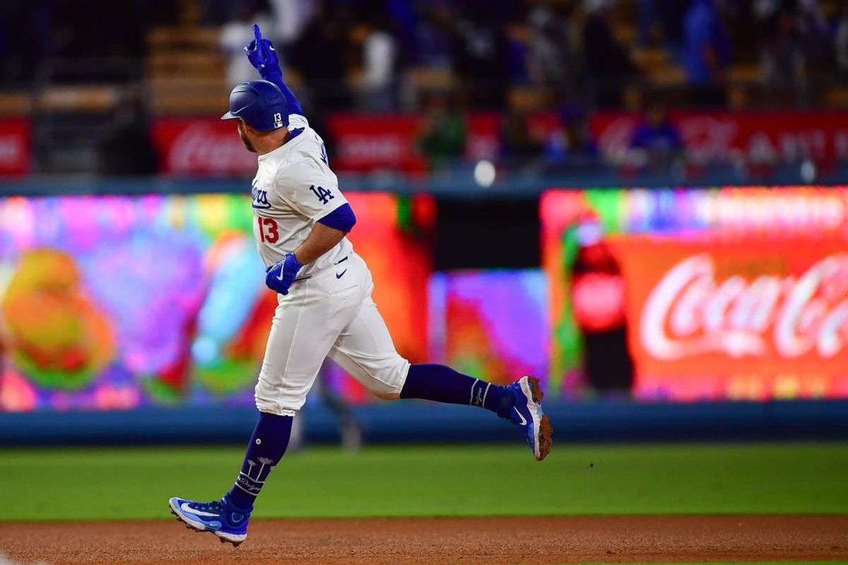 May 4, 2024; Los Angeles, California, USA; Los Angeles Dodgers third baseman Max Muncy (13) runs the bases after hitting a solo home run against the Atlanta Braves during the eighth inning at Dodger Stadium.