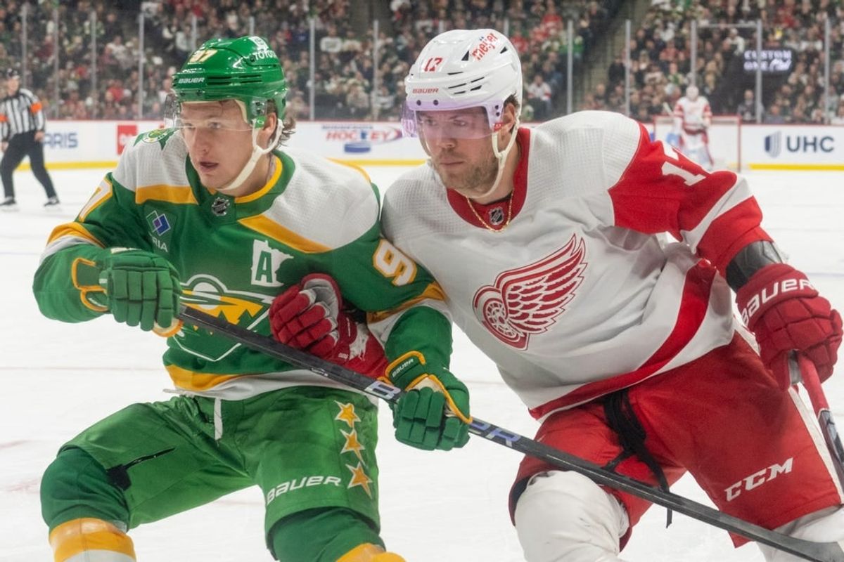 Dec 27, 2023; Saint Paul, Minnesota, USA; Detroit Red Wings right wing Daniel Sprong (17) checks Minnesota Wild left wing Kirill Kaprizov (97) in the first period at Xcel Energy Center.