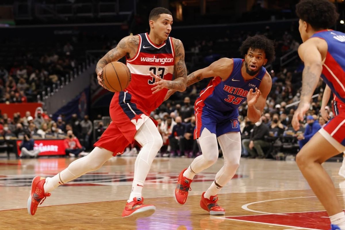 Feb 14, 2022; Washington, District of Columbia, USA; Washington Wizards forward Kyle Kuzma (33) drives to the basket past Detroit Pistons forward Marvin Bagley III (35) in the fourth quarter at Capital One Arena.