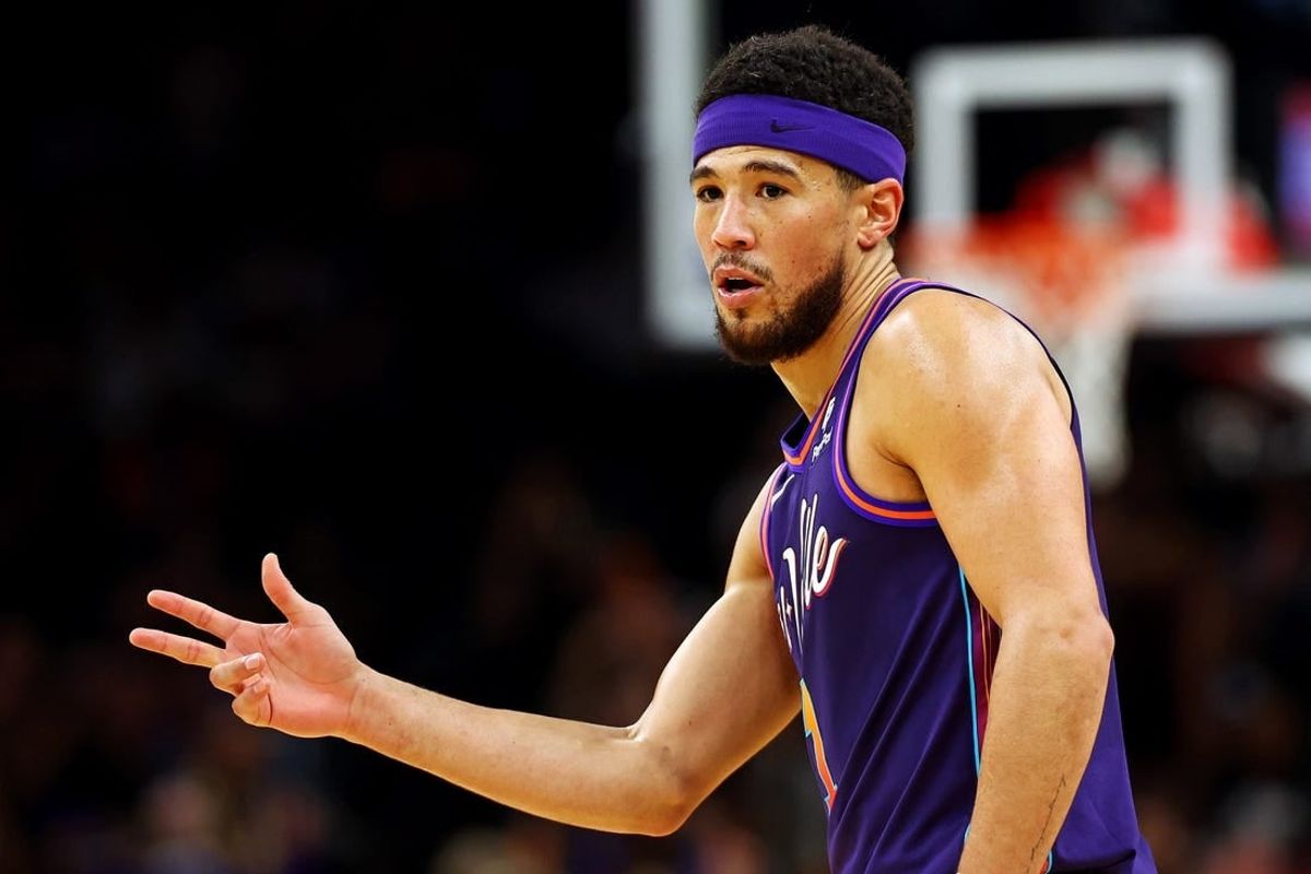 Feb 25, 2024; Phoenix, Arizona, USA; Phoenix Suns guard Devin Booker (1) reacts after a play during the first quarter of the game against the Los Angeles Lakers at Footprint Center.