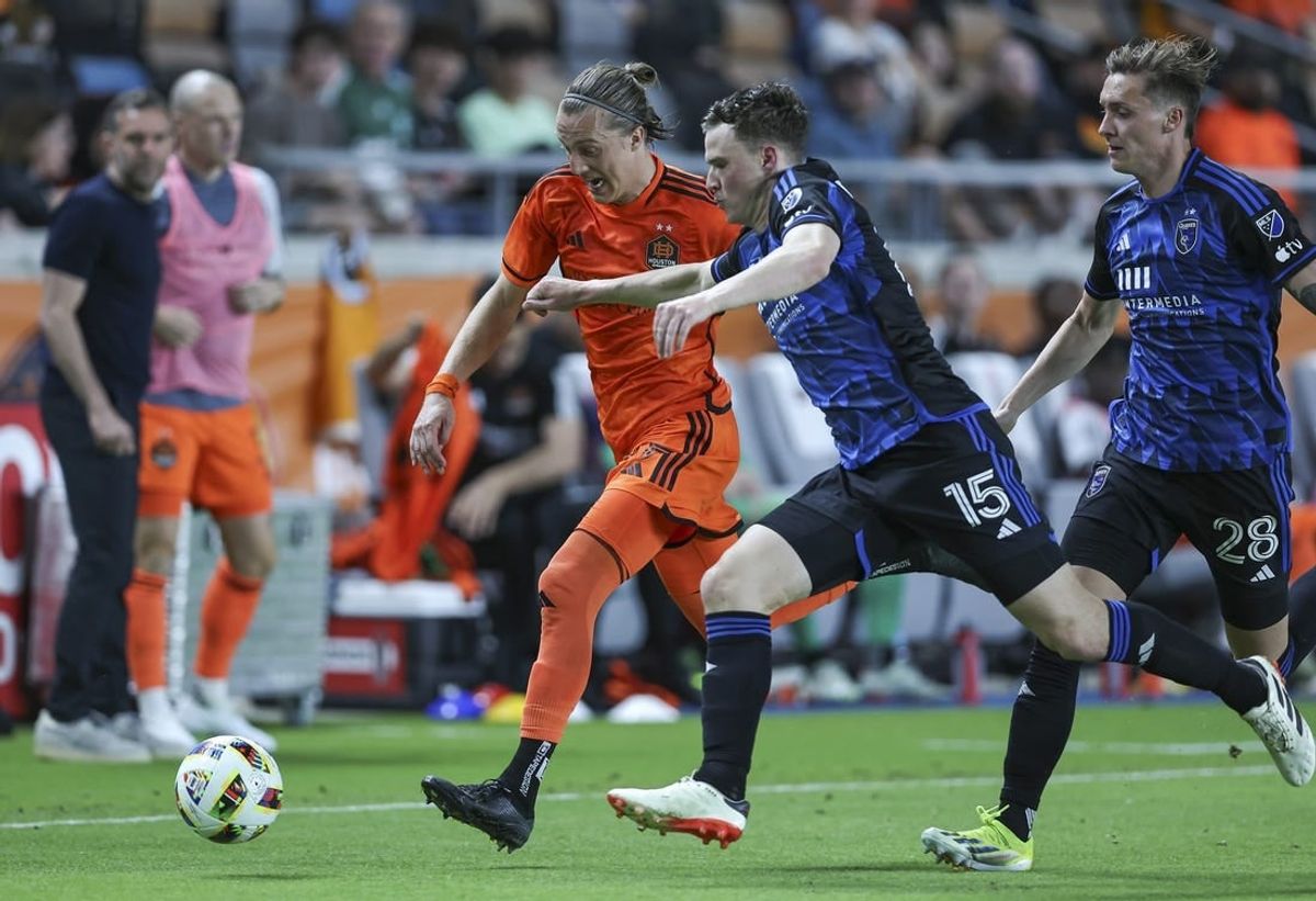 Mar 30, 2024; Houston, Texas, USA; Houston Dynamo FC midfielder Griffin Dorsey (25) attempts to advance the ball as San Jose Earthquakes defender Tanner Beason (15) defends during the second half at Shell Energy Stadium.