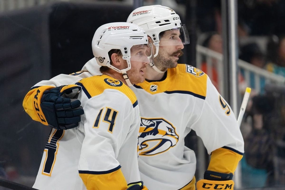 Feb 24, 2024; San Jose, California, USA; Nashville Predators left wing Filip Forsberg (9) hugs center Gustav Nyquist (14) after scoring a goal during the third period against the San Jose Sharks at SAP Center at San Jose.