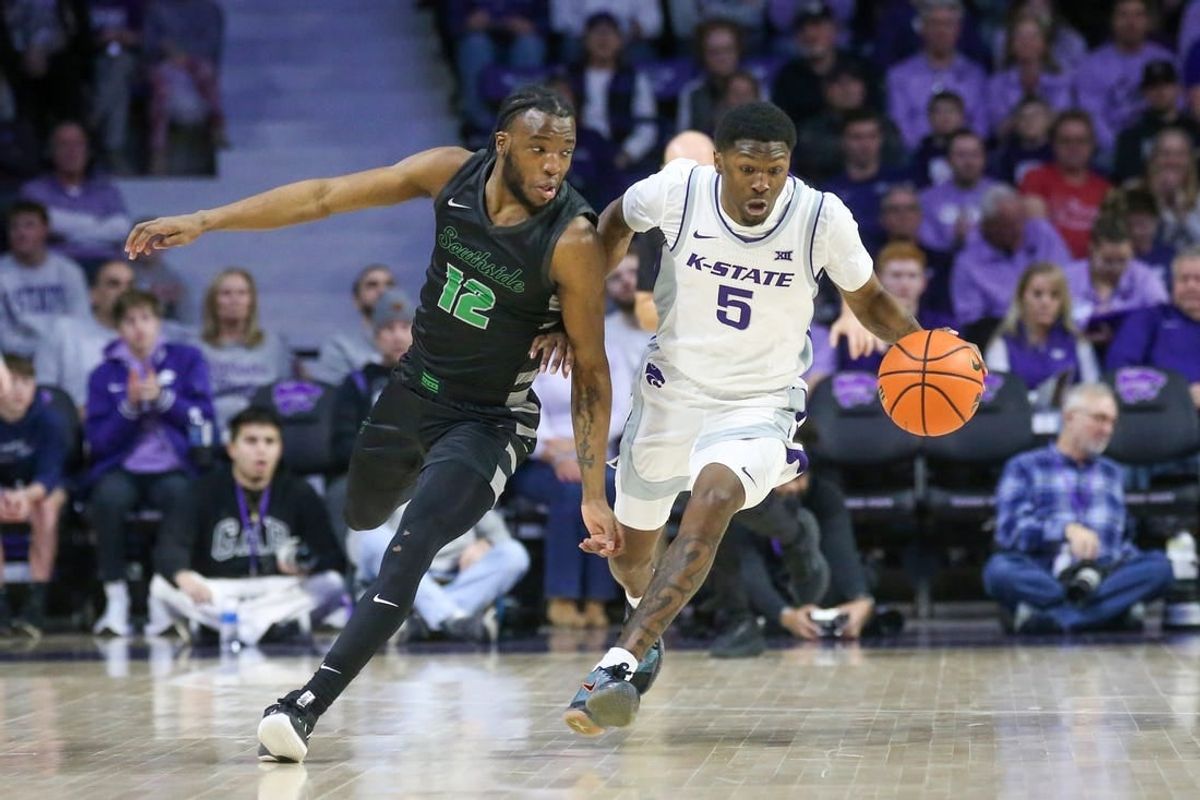 Jan 2, 2024; Manhattan, Kansas, USA; Kansas State Wildcats guard Cam Carter (5) brings the ball up court against Chicago State Cougars guard Brent Davis (12) during the first half at Bramlage Coliseum.