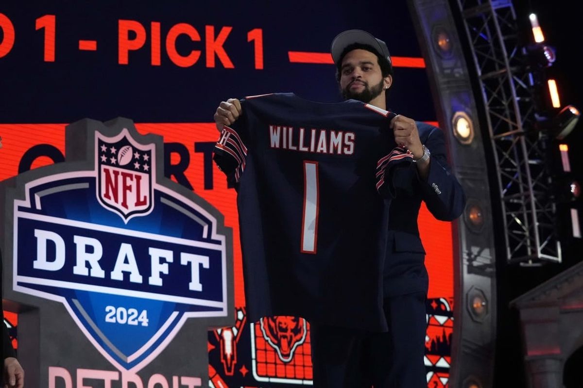 Apr 25, 2024; Detroit, MI, USA; Southern California Trojans quarterback Caleb Williams poses with jersey after being chosen as the No. 1 pick in the first round during the 2024 NFL Draft at Campus Martius Park and Hart Plaza.