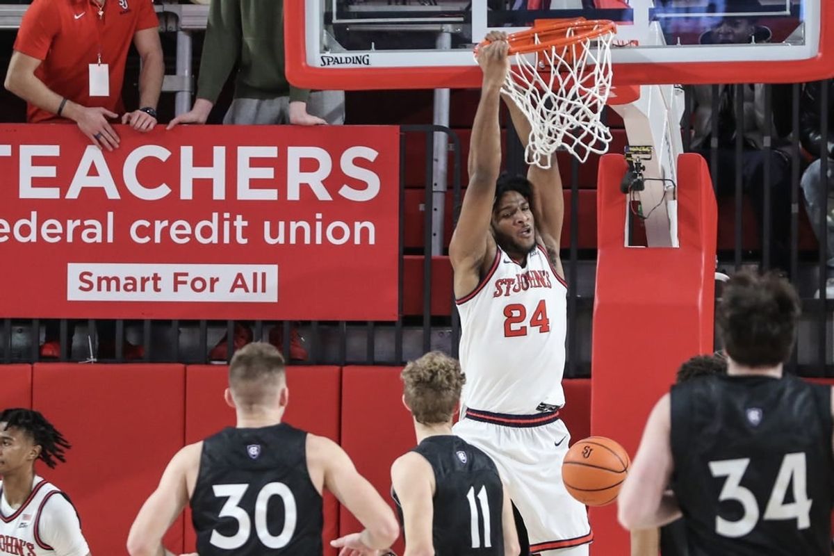 Nov 25, 2023; Queens, New York, USA; St. John's Red Storm forward Zuby Ejiofor (24) dunks in the first half against the Holy Cross Crusaders at Carnesecca Arena.
