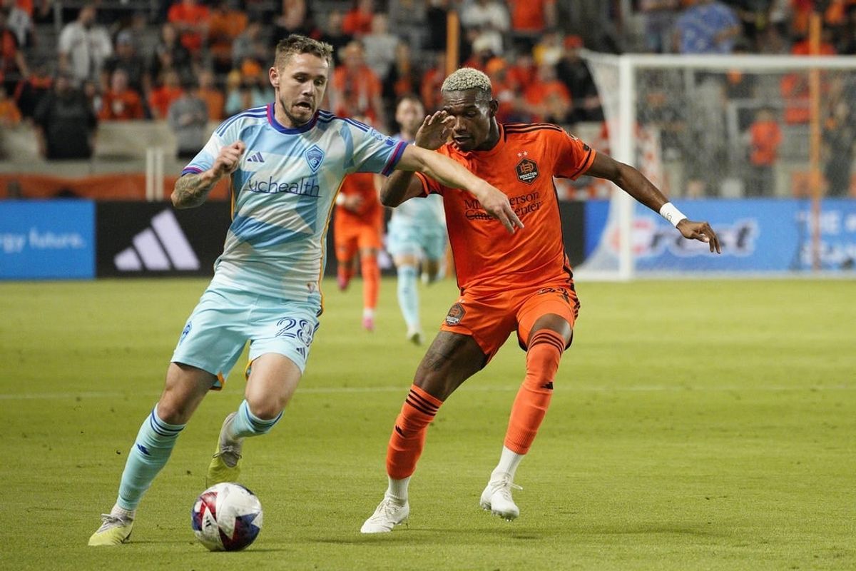 Oct 7, 2023; Houston, Texas, USA; Colorado Rapids midfielder Sam Nicholson (28) dribbles against Houston Dynamo forward Nelson Quinones (21) during the first half at Shell Energy Stadium.