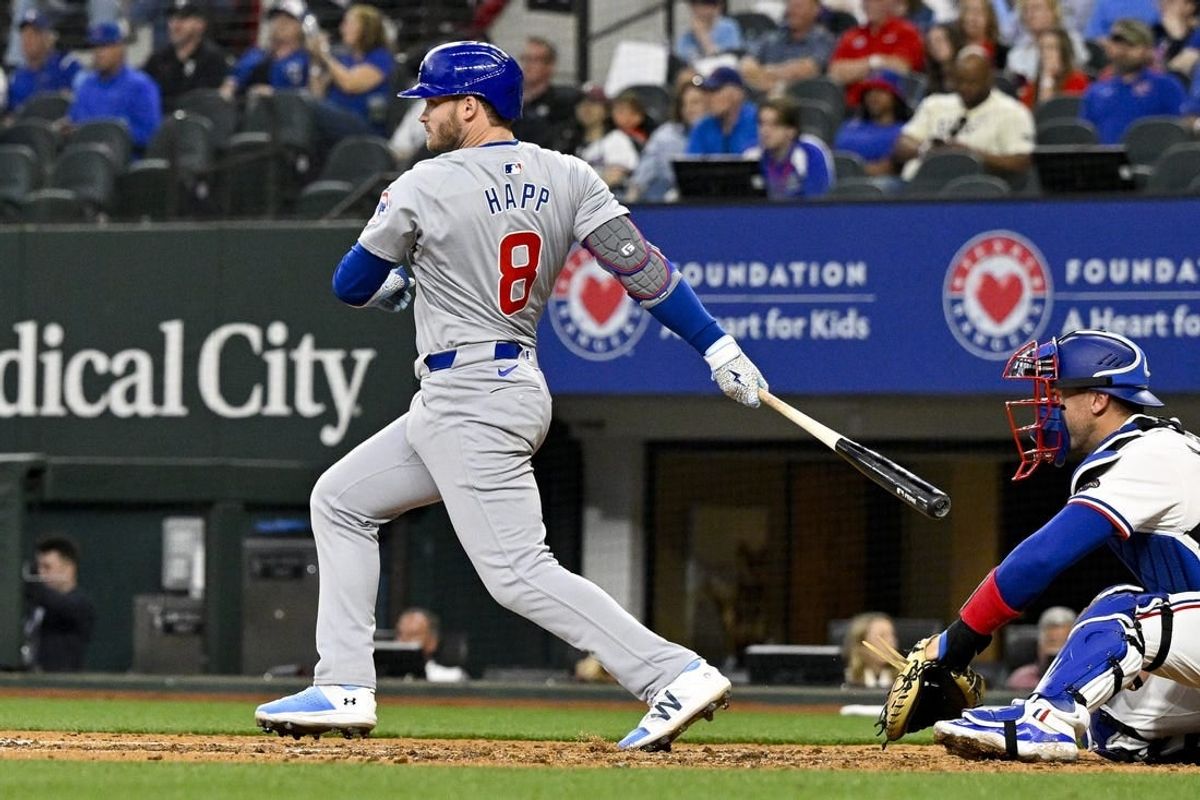 Mar 31, 2024; Arlington, Texas, USA; Chicago Cubs designated hitter Ian Happ (8) hits a double and drives in two runs during the fourth inning against the Texas Rangers at Globe Life Field.