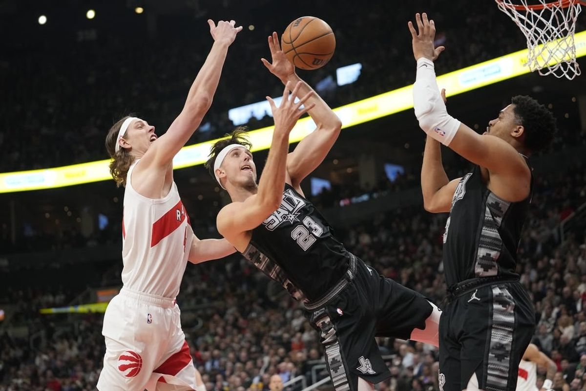 Feb 12, 2024; Toronto, Ontario, CAN; Toronto Raptors forward Kelly Olynyk (41) and San Antonio Spurs forward Zach Collins (23) and forward Keldon Johnson (3) battle for a rebound during the first half at Scotiabank Arena.