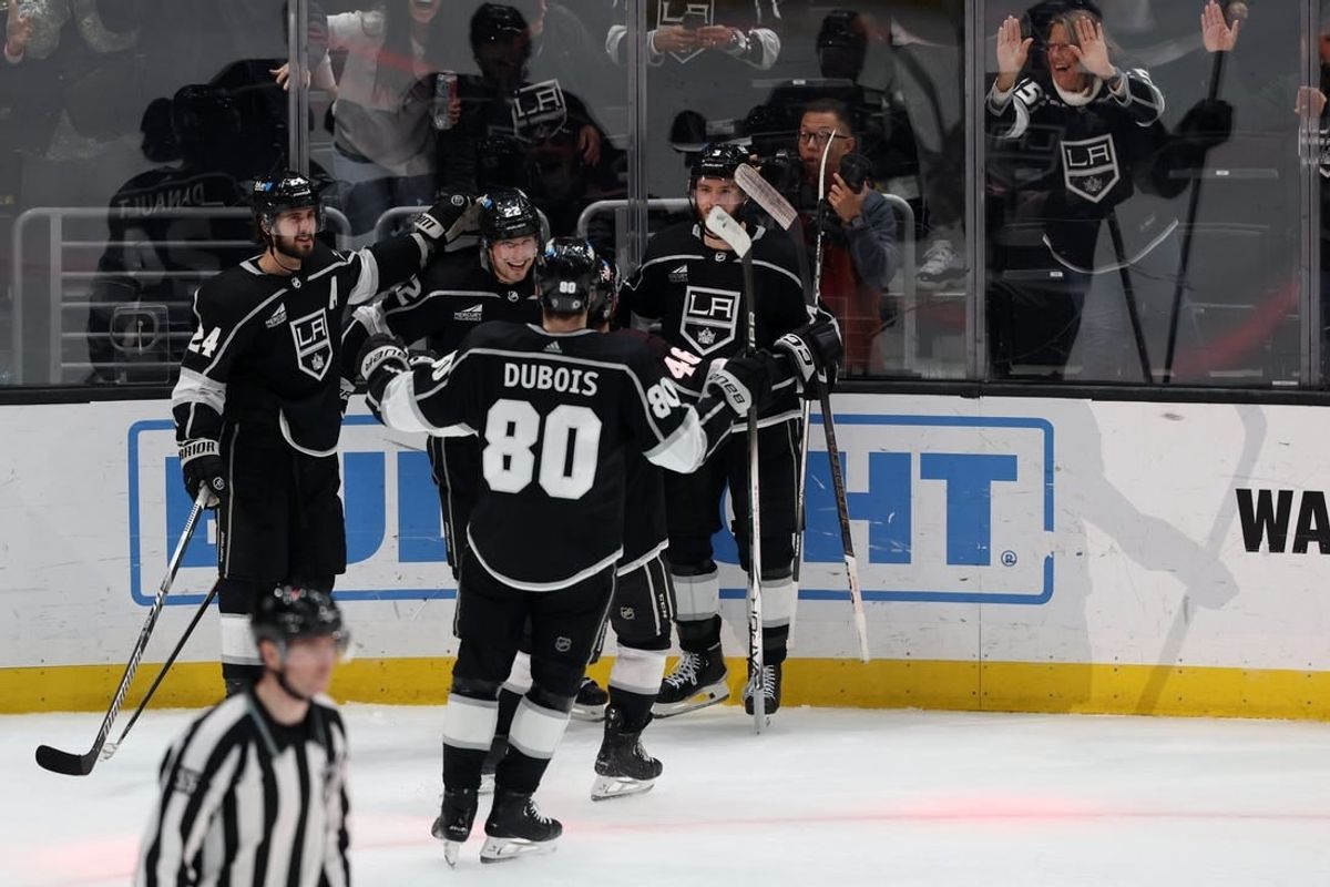 Mar 7, 2024; Los Angeles, California, USA;  Los Angeles Kings left wing Kevin Fiala (22, center) celebrates a goal with center Phillip Danault (24) and defenseman Matt Roy (3) and center Pierre-Luc Dubois (80) during the overtime against the Ottawa Senators at Crypto.com Arena.