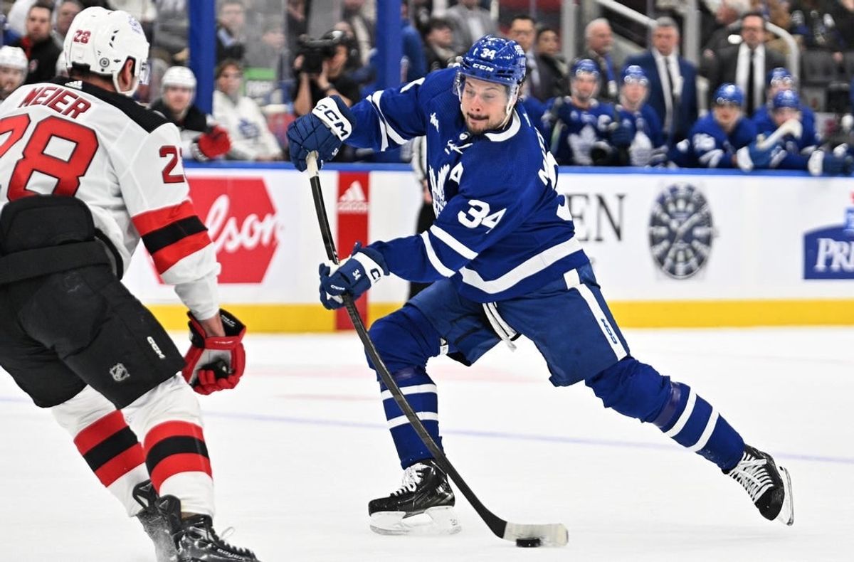 Apr 11, 2024; Toronto, Ontario, CAN; Toronto Maple Leafs forward Auston Matthews (34) shoots the puck past New Jersey Devils forward Timo Meier (28) in the first period at Scotiabank Arena.