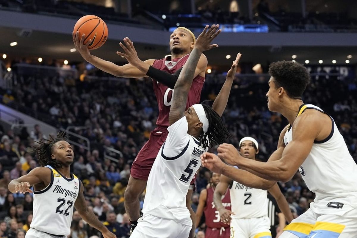 Nov 10, 2023; Milwaukee, Wisconsin, USA;  Rider Broncs guard D.J. Dudley (0) shoots against Marquette Golden Eagles guard Tre Norman (5) during the second half at Fiserv Forum.