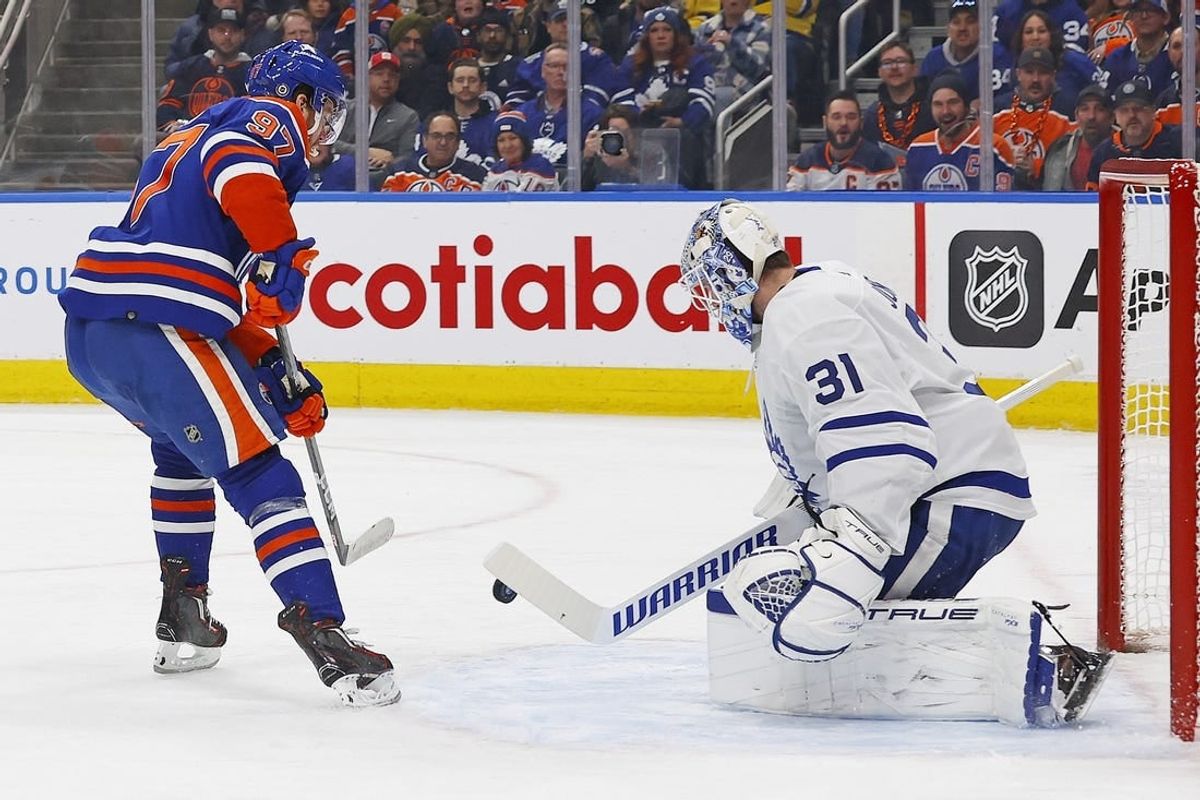 Jan 16, 2024; Edmonton, Alberta, CAN; Toronto Maple Leafs goaltender Martin Jones (31) makes a save on one Edmonton Oilers forward Connor McDavid (97) during the first period at Rogers Place.
