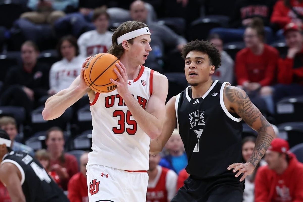 Nov 30, 2023; Salt Lake City, Utah, USA; Utah Utes center Branden Carlson (35) looks to pass the ball against Hawaii Warriors forward Justin McKoy (1) during the first half at Delta Center.