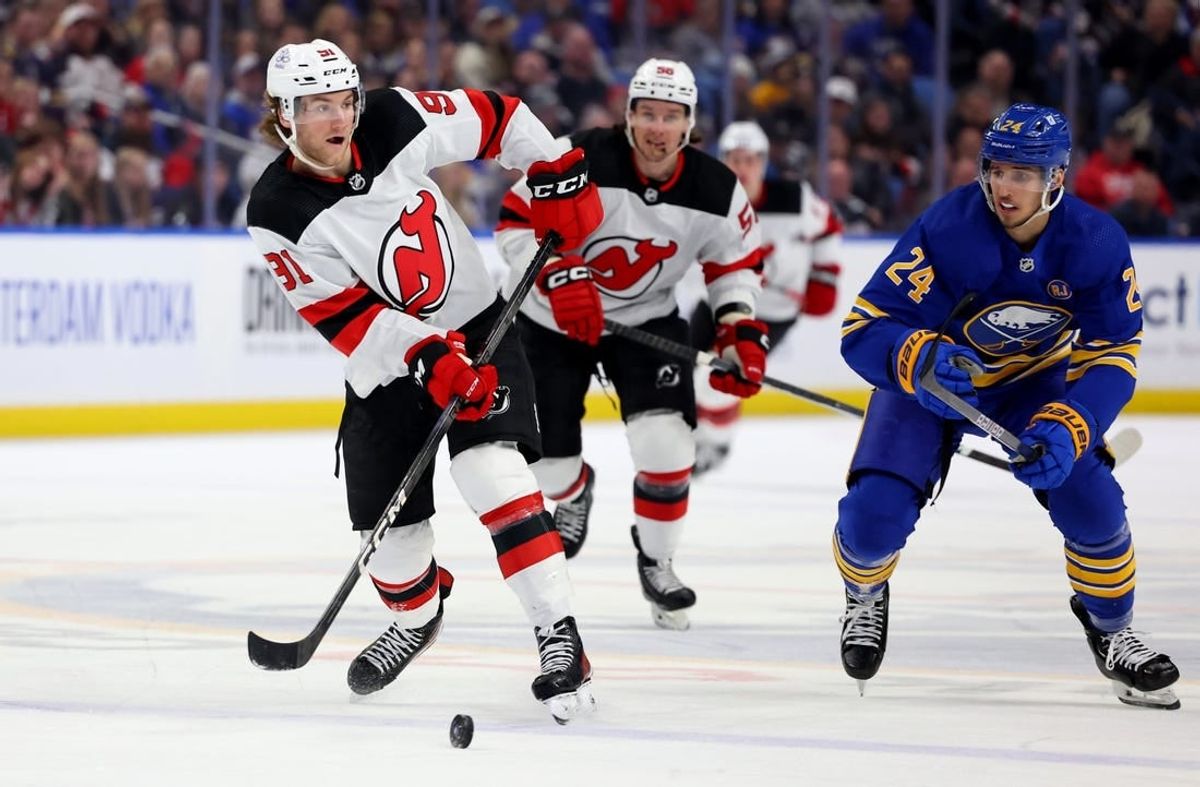 Mar 29, 2024; Buffalo, New York, USA;  Buffalo Sabres center Dylan Cozens (24) watches as New Jersey Devils center Dawson Mercer (91) makes a pass during the third period at KeyBank Center.