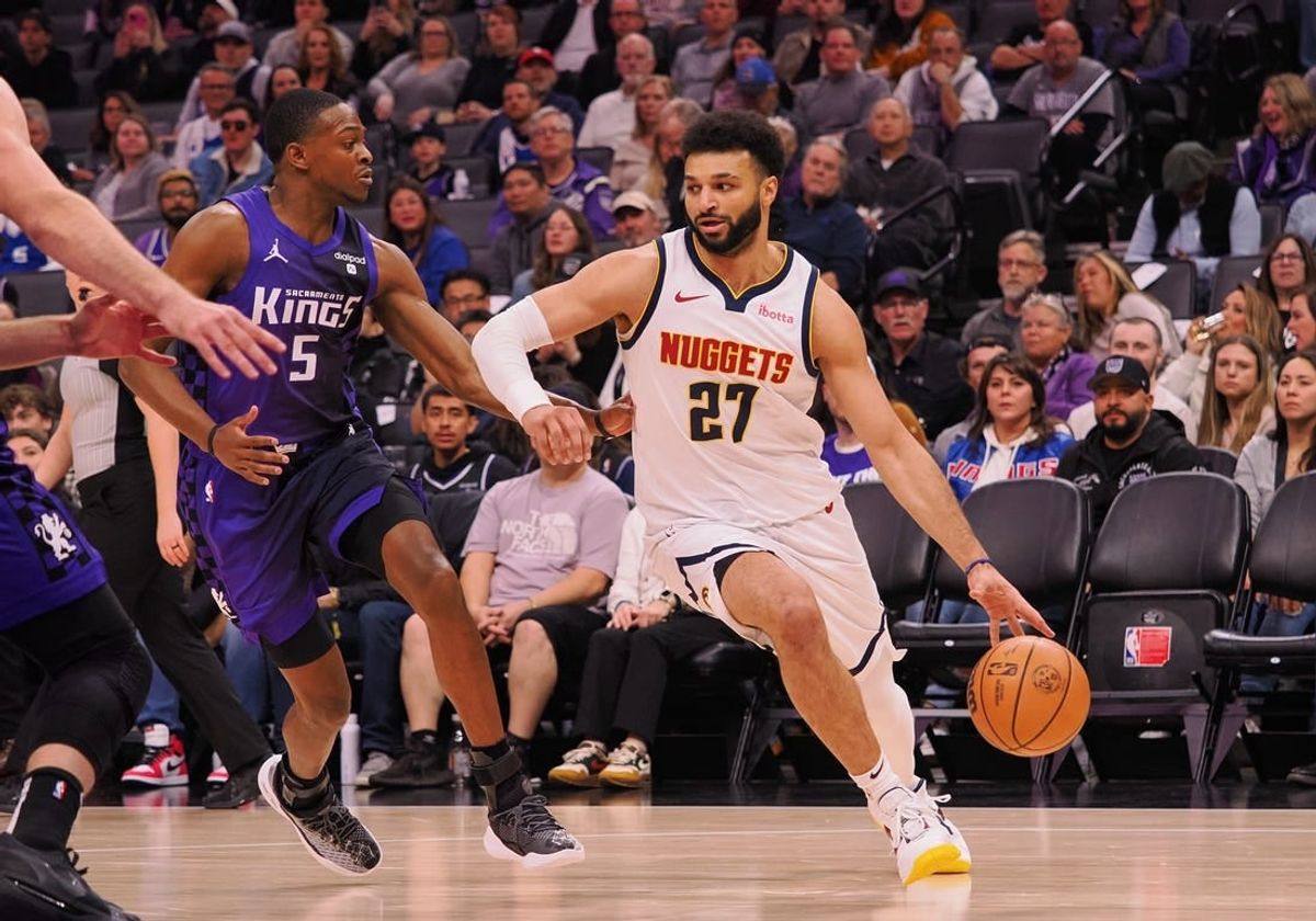 Feb 9, 2024; Sacramento, California, USA; Denver Nuggets guard Jamal Murray (27) controls the ball against Sacramento Kings guard De'Aaron Fox (5) during the first quarter at Golden 1 Center.