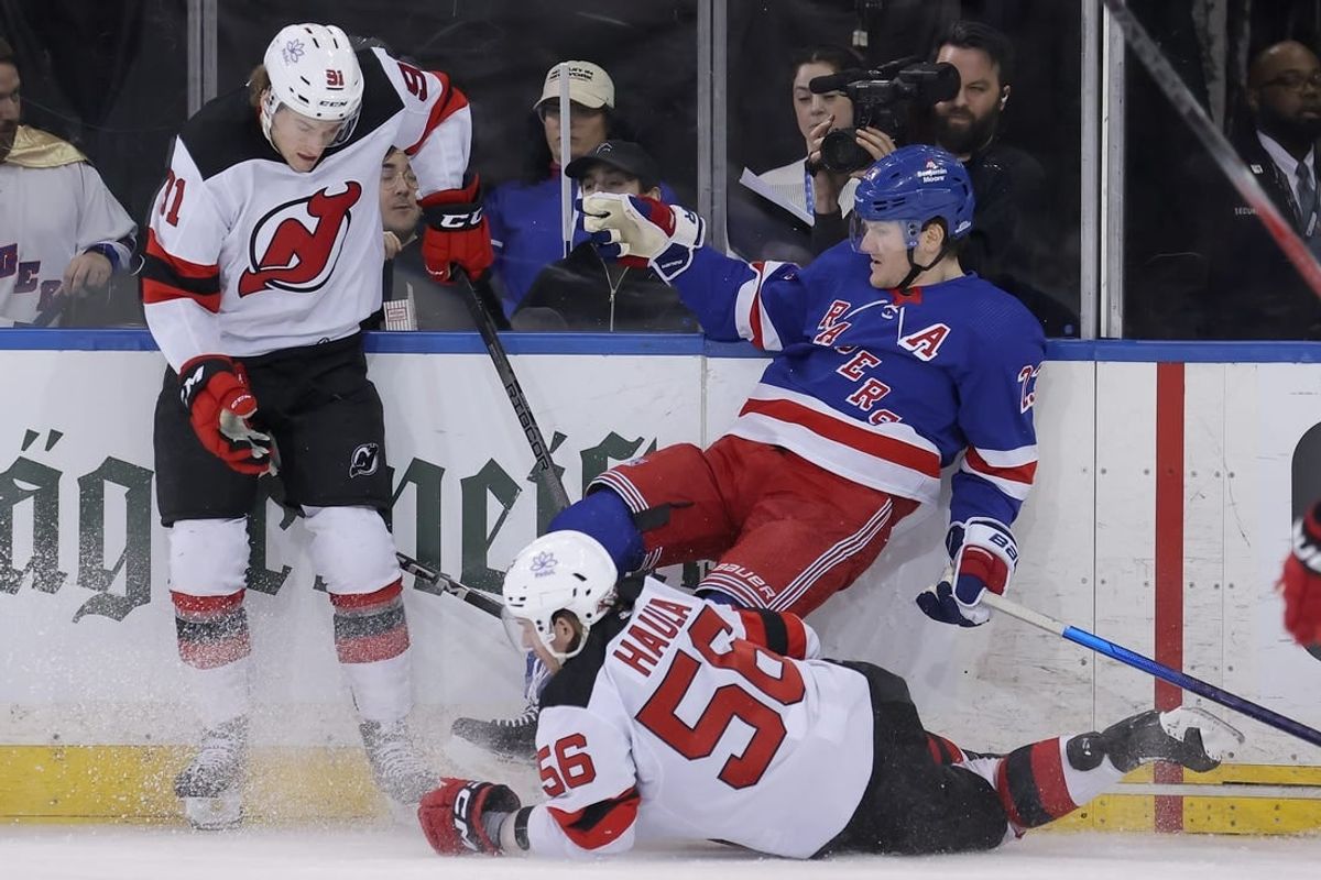 Mar 11, 2024; New York, New York, USA; New Jersey Devils center Dawson Mercer (91) and left wing Erik Haula (56) hit New York Rangers defenseman Adam Fox (23) during the second period at Madison Square Garden.