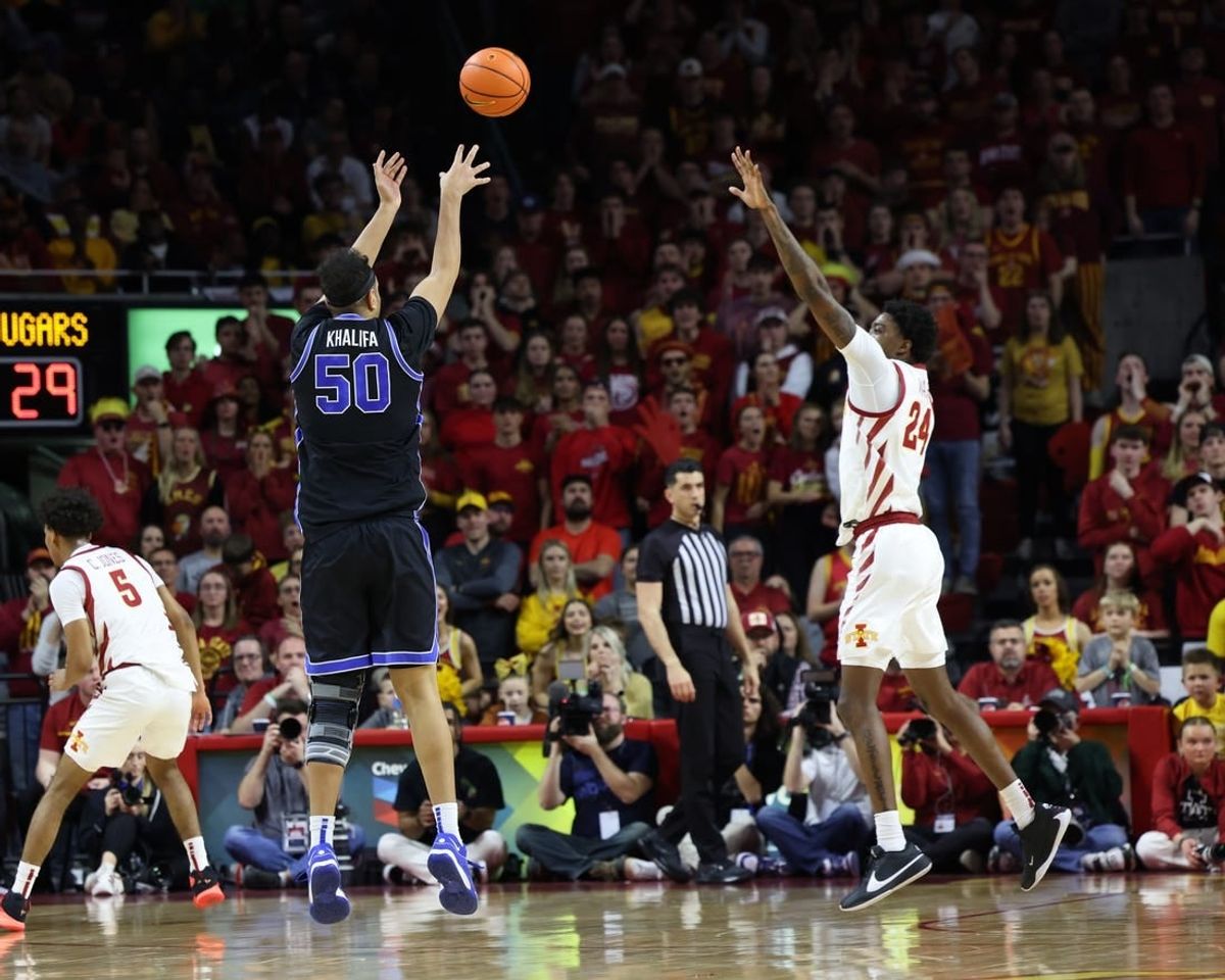 Mar 6, 2024; Ames, Iowa, USA;  Brigham Young Cougars center Aly Khalifa (50) shoots over Iowa State Cyclones forward Hason Ward (24) at James H. Hilton Coliseum.