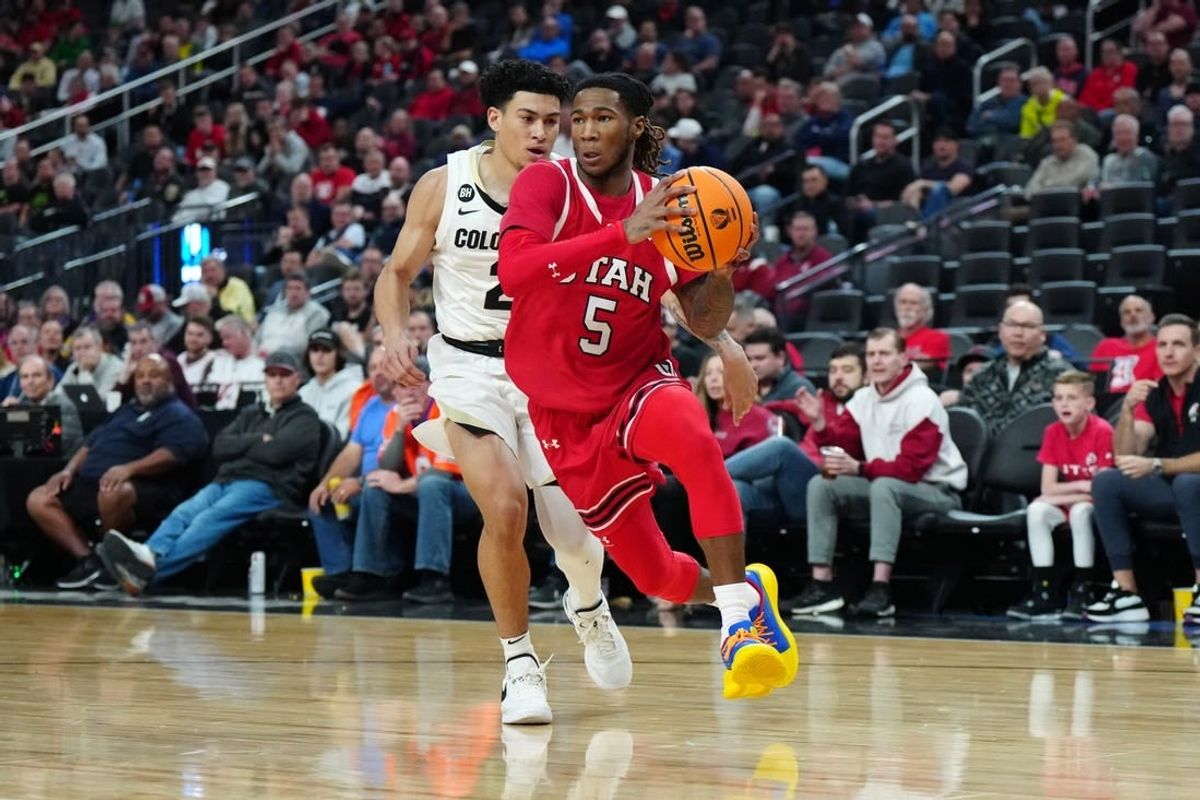 Mar 14, 2024; Las Vegas, NV, USA; Utah Utes guard Deivon Smith (5) drives to the basket against Colorado Buffaloes guard KJ Simpson (2) in the first half at T-Mobile Arena.