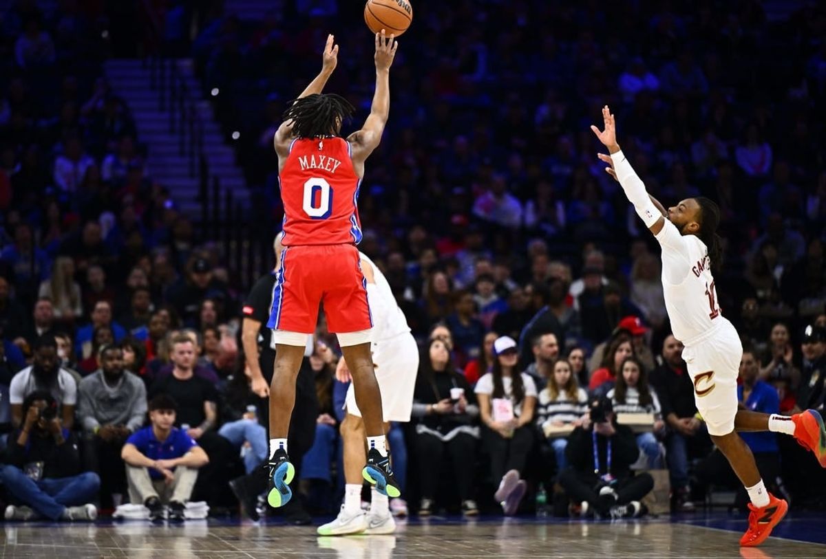 Feb 23, 2024; Philadelphia, Pennsylvania, USA; Philadelphia 76ers guard Tyrese Maxey (0) shoots against Cleveland Cavaliers guard Darius Garland (10) in the first quarter at Wells Fargo Center.