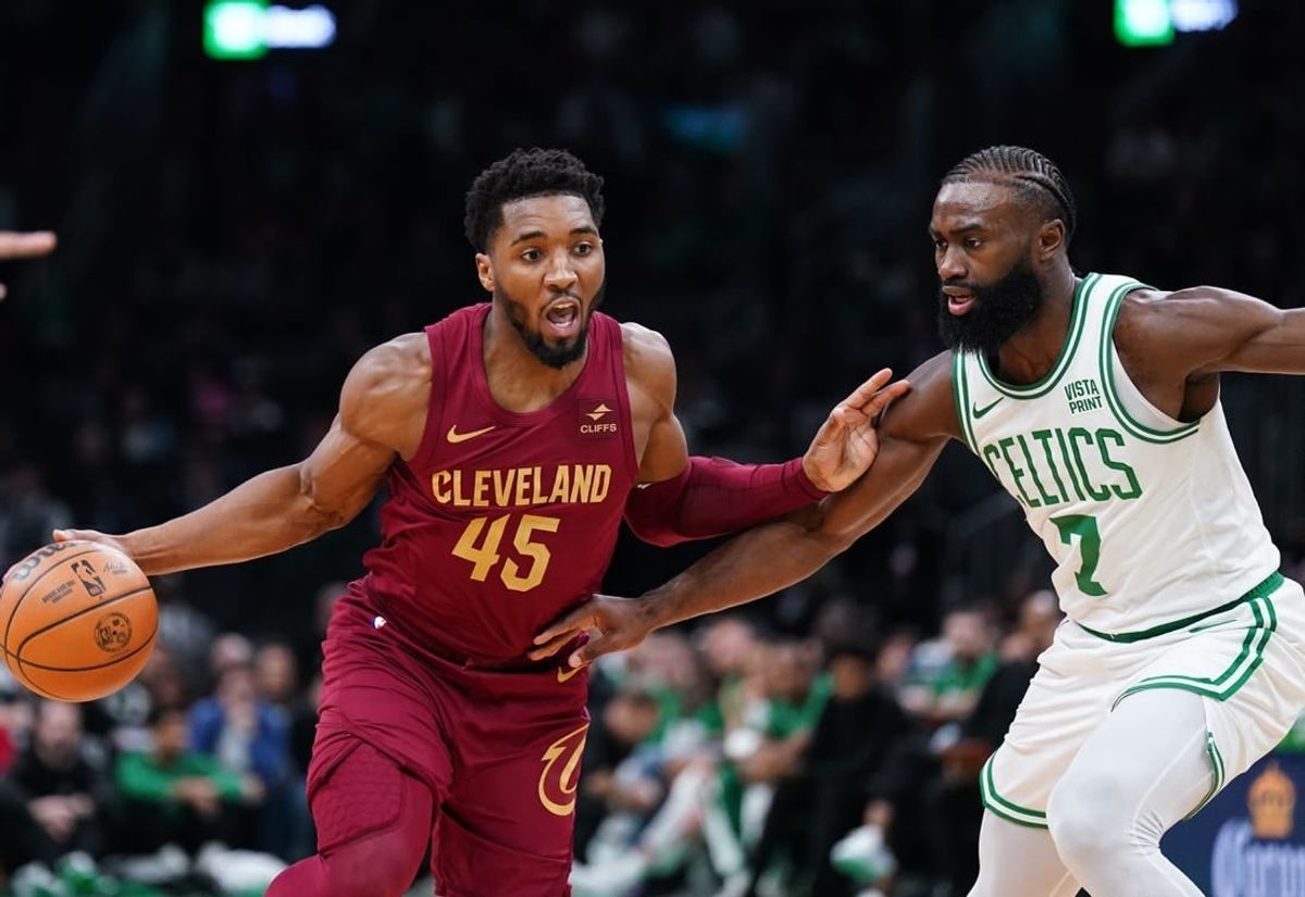 Dec 14, 2023; Boston, Massachusetts, USA; Cleveland Cavaliers guard Donovan Mitchell (45) drives the ball against Boston Celtics guard Jaylen Brown (7) in the first quarter at TD Garden.