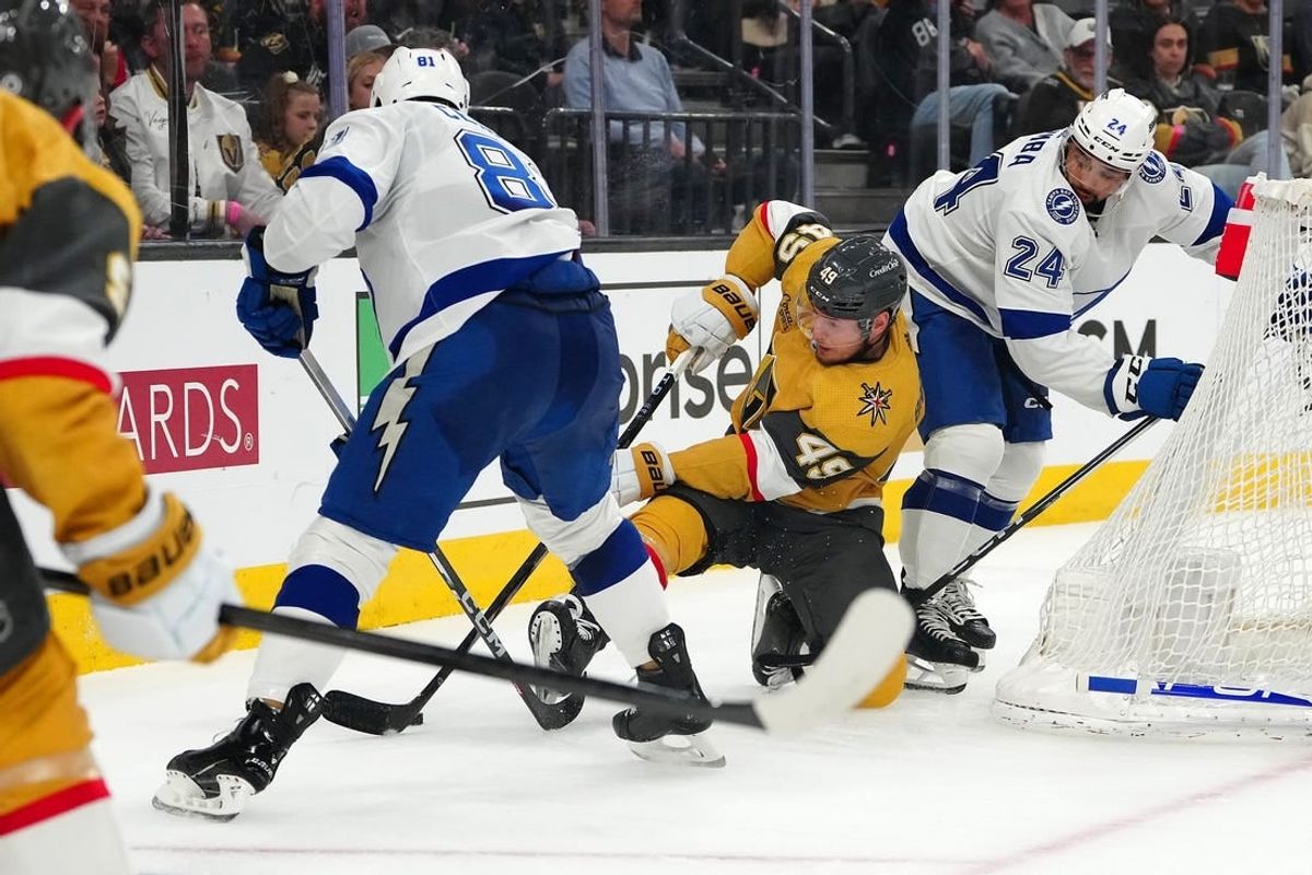 Mar 19, 2024; Las Vegas, Nevada, USA; Vegas Golden Knights center Ivan Barbashev (49) attempts to control the puck between Tampa Bay Lightning defenseman Erik Cernak (81) and Tampa Bay Lightning defenseman Matt Dumba (24) during the second period at T-Mobile Arena.