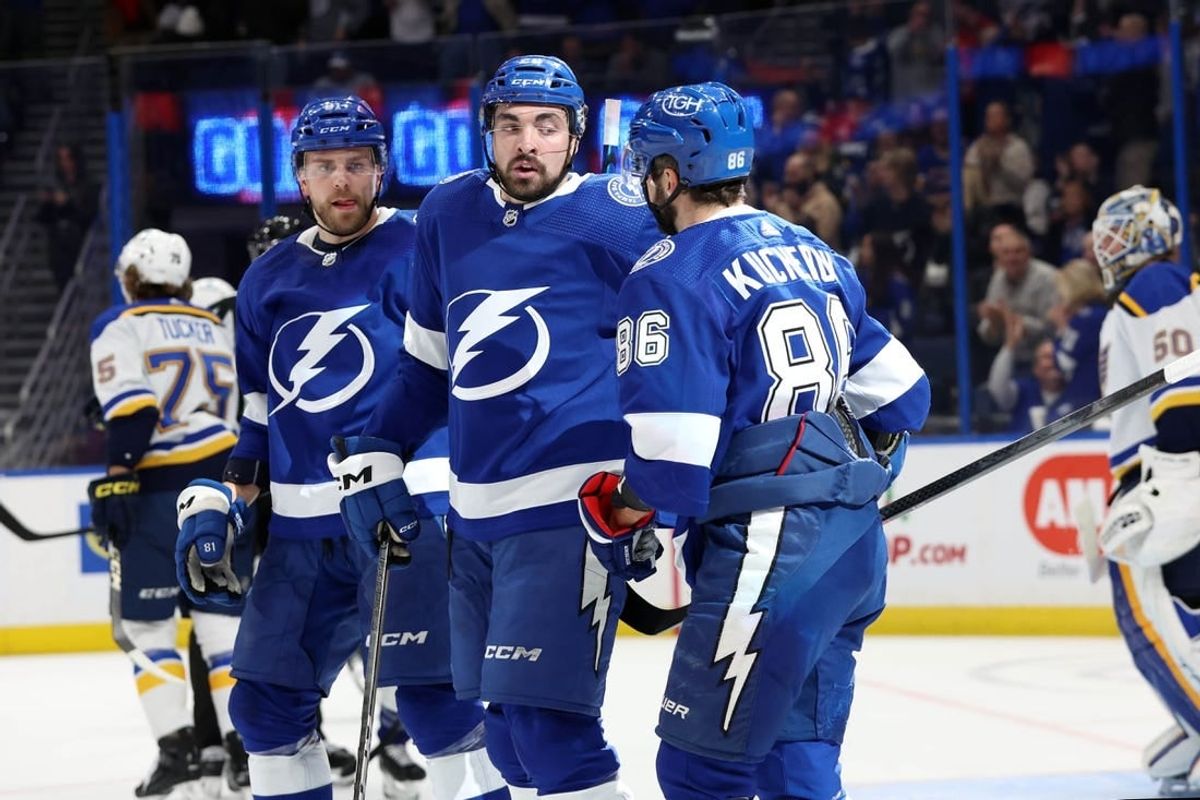 Dec 19, 2023; Tampa, Florida, USA; Tampa Bay Lightning right wing Nikita Kucherov (86) is congratulated after he scored during the first period against the St. Louis Blues at Amalie Arena.