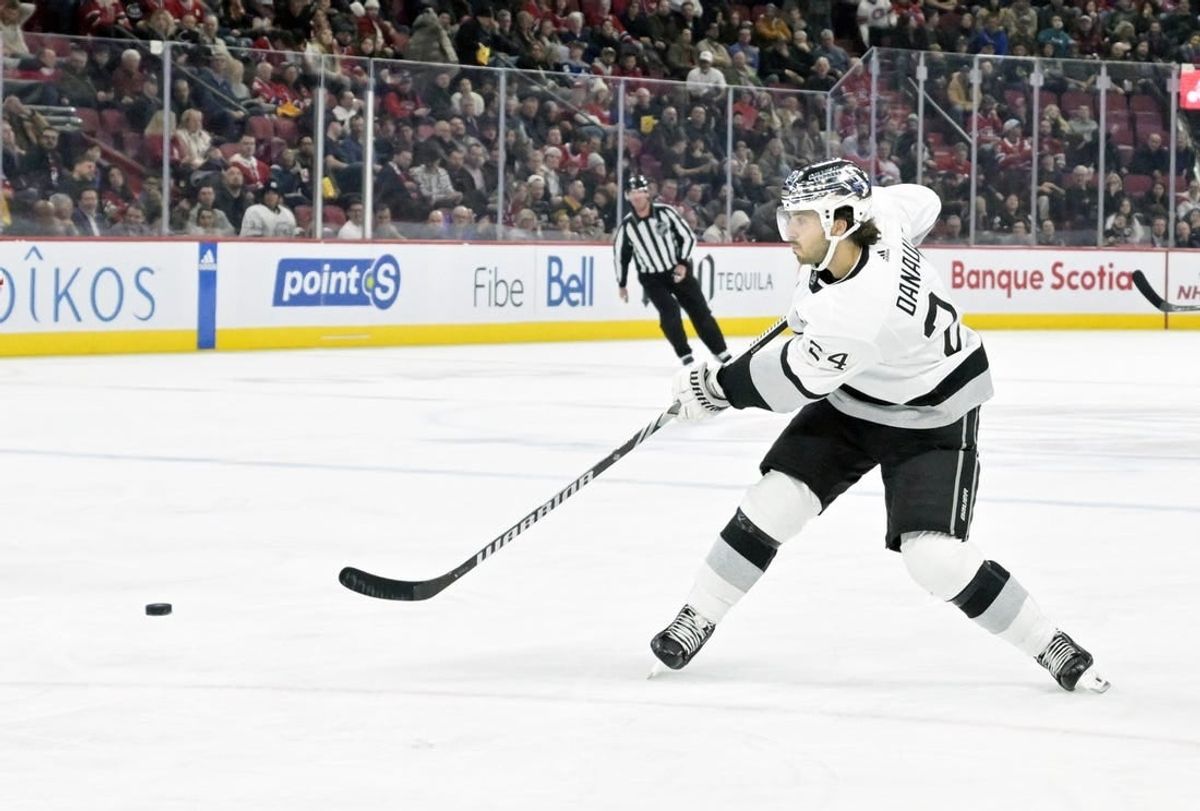Dec 7, 2023; Montreal, Quebec, CAN; Los Angeles Kings forward Philllip Danault (24) takes a shot on the Montreal Canadiens net during the third period at the Bell Centre.