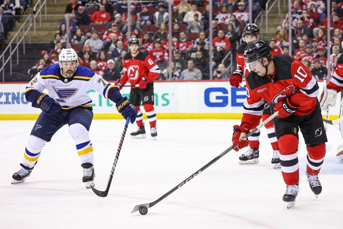 Mar 7, 2024; Newark, New Jersey, USA; New Jersey Devils right wing Alexander Holtz (10) clears the puck in front of St. Louis Blues defenseman Justin Faulk (72) during the second period at Prudential Center.