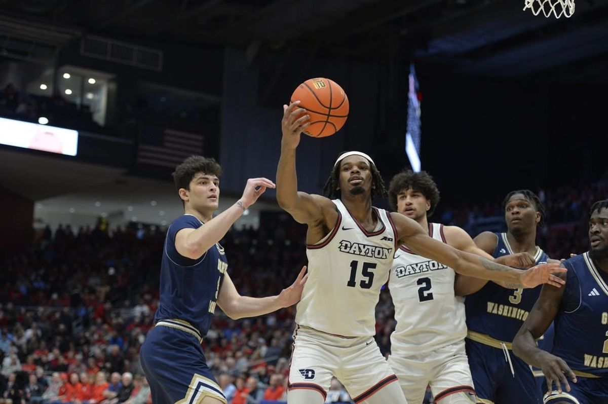 Jan 30, 2024; Dayton, Ohio, USA;  Dayton Flyers forward DaRon Holmes II (15) grabs a rebound against George Washington guard Garrett Johnson (9) during the game at University of Dayton Arena.