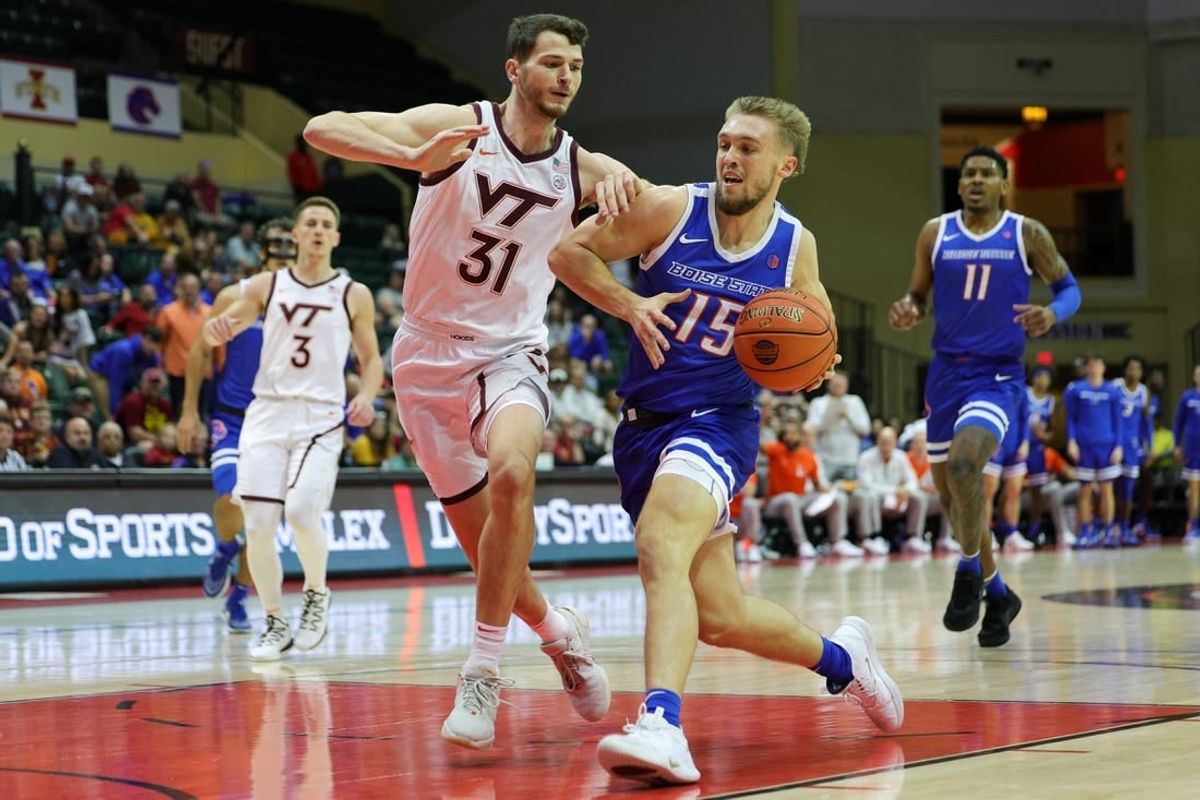 Nov 23, 2023; Kissimmee, FL, USA;  Boise State Broncos guard Jace Whiting (15) drives to the basket past Virginia Tech Hokies forward Robbie Beran (31) in the first half during the ESPN Events Invitational at State Farm Field House.