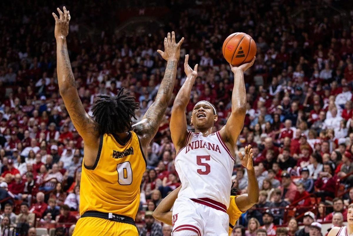 Dec 29, 2023; Bloomington, Indiana, USA; Indiana Hoosiers forward Malik Reneau (5) shoots the ball while Kennesaw State Owls forward Demond Robinson (0) and  guard Terrell Burden (1) defend in the first half at Simon Skjodt Assembly Hall.