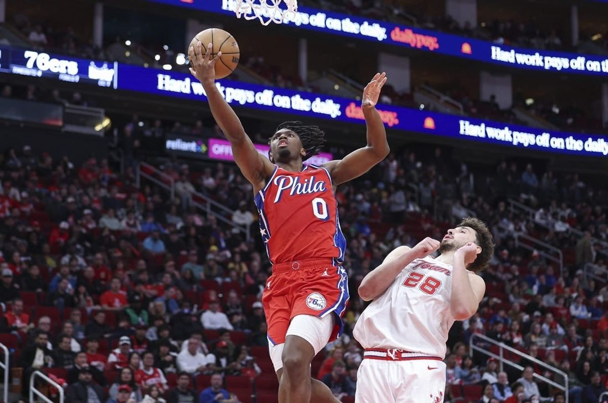 Dec 29, 2023; Houston, Texas, USA; Philadelphia 76ers guard Tyrese Maxey (0) shoots the ball as Houston Rockets center Alperen Sengun (28) defends during the third quarter at Toyota Center.