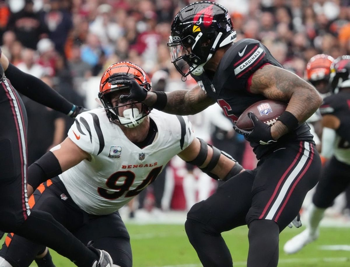 Oct 8, 2023; Glendale, Arizona, United States; Arizona Cardinals running back James Conner (6) stiff arms Cincinnati Bengals defensive end Sam Hubbard (94) at State Farm Stadium.