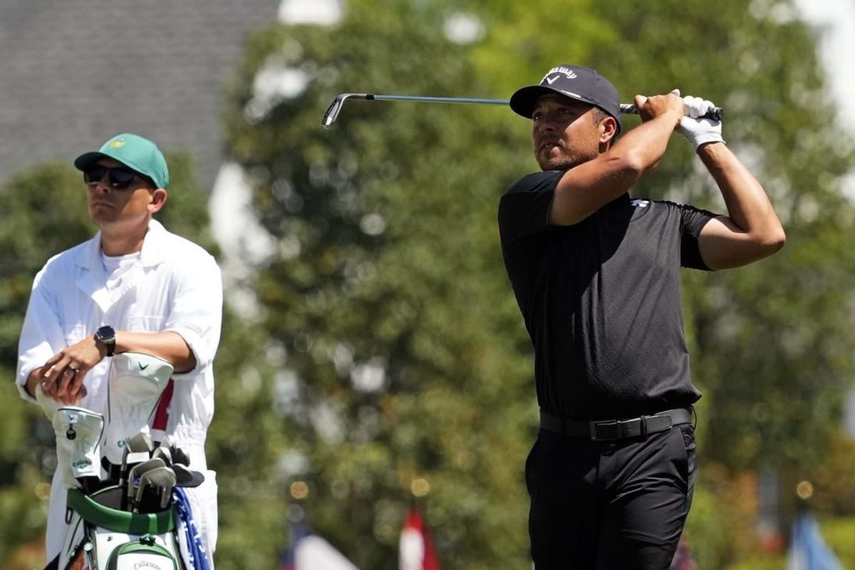 Apr 14, 2024; Augusta, Georgia, USA; Xander Schauffele plays from the fairway on the first hole during the final round of the Masters Tournament.