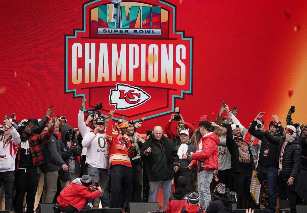 Kansas City Chiefs head coach Andy Reid celebrates with quarterback Patrick Mahomes (15) and other players in 2023 during the Kansas City Chiefs Super Bowl parade.