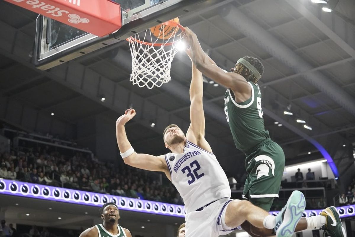 Jan 7, 2024; Evanston, Illinois, USA; Michigan State Spartans forward Coen Carr (55) goes up for a dunk on Northwestern Wildcats forward Blake Preston (32) during the first half at Welsh-Ryan Arena.